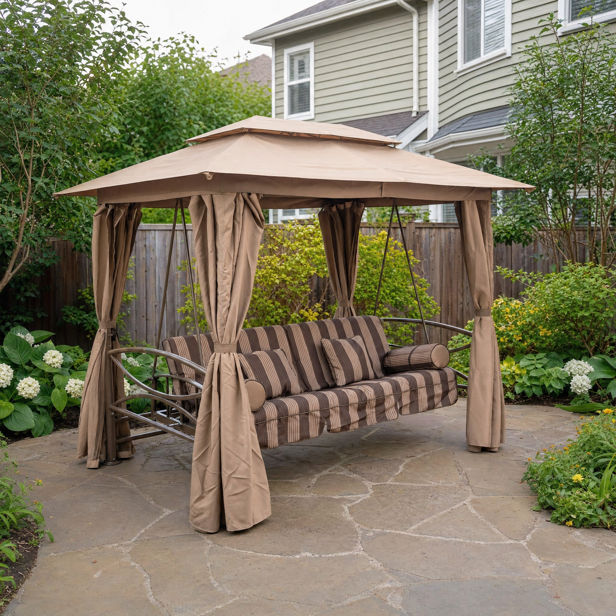 Three-person porch swing with tan canopy, curtains and brown striped cushions