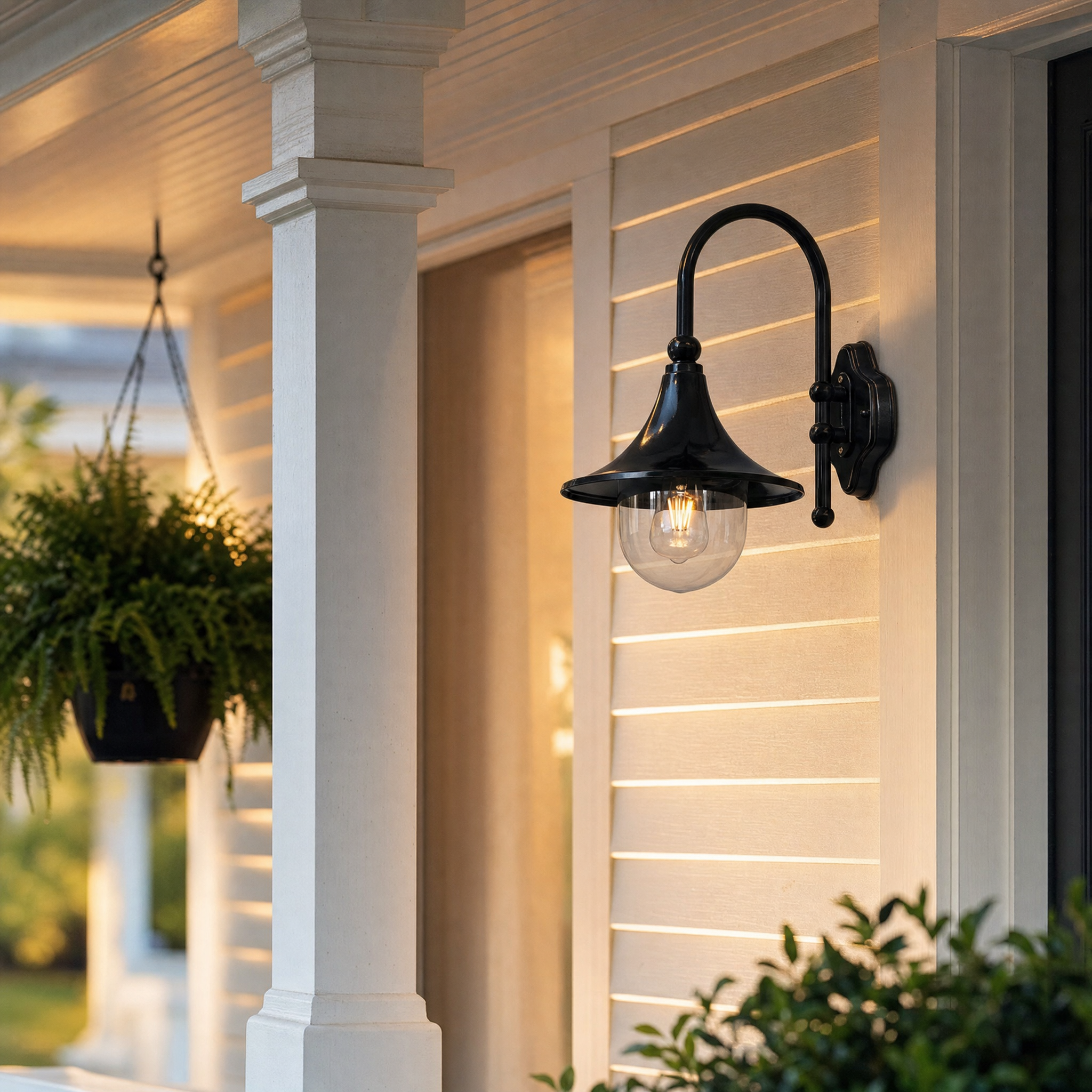 Vintage gooseneck wall lantern on a covered front porch in the evening