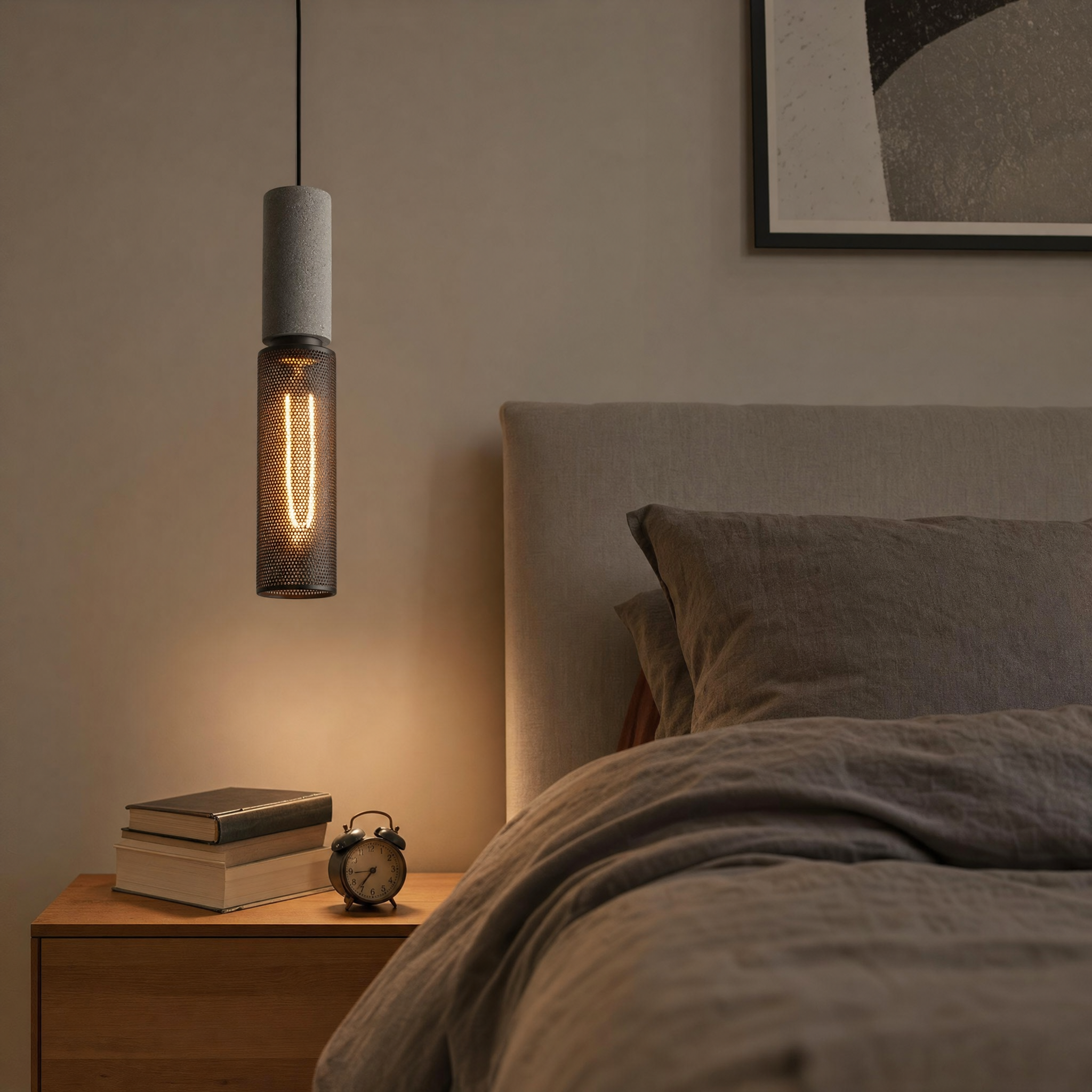 Concrete cylinder pendant beside bed as bedside light