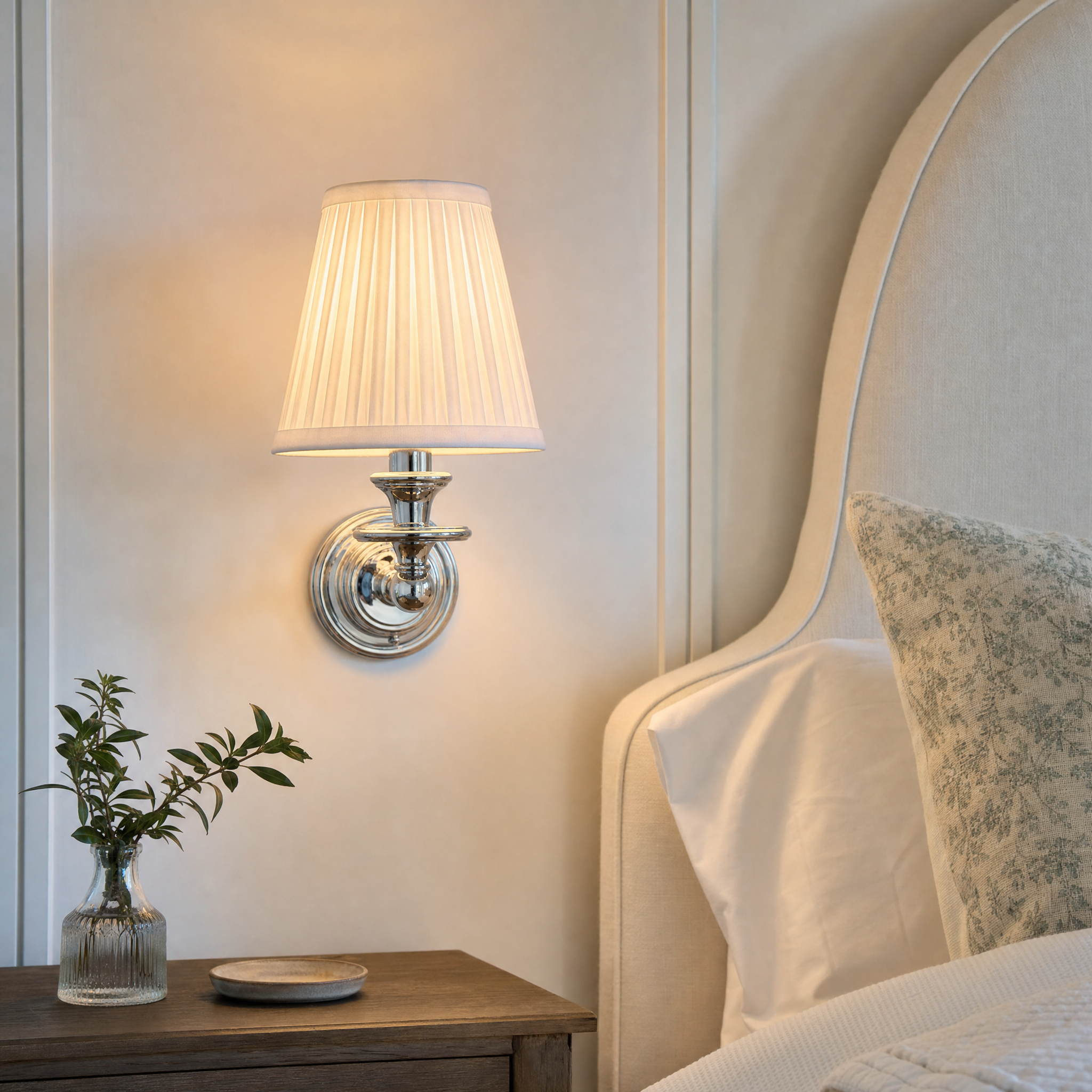 Rowan drum shade wall sconce beside upholstered bed